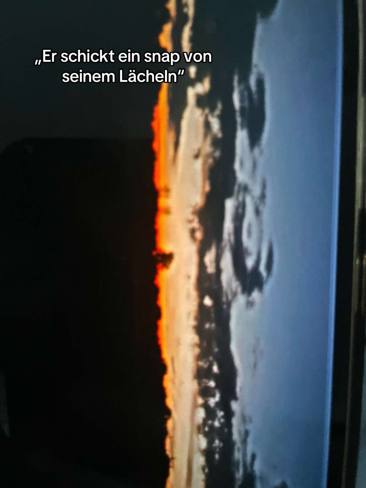 @~M